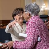 Reps. Beatty and Kim embrace at the Financial Literacy Resource Fair